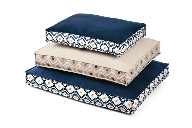 Three sizes of rectangle P.L.A.Y. Marina Boxy Bed with a striped design and reversible cover stacked together.