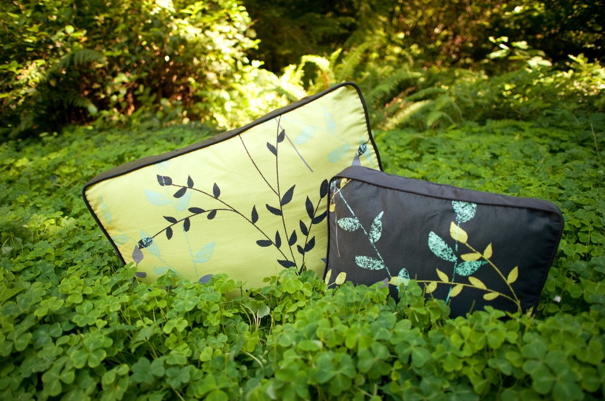 two greenery rectangle dog beds sitting in green plants