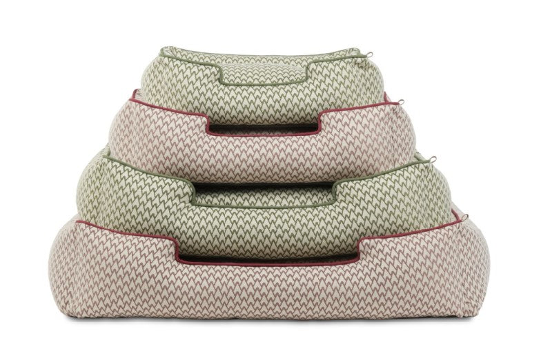 Stack of P.L.A.Y. Vineyard Lounge Beds in cabernet red and olive green, showcasing bolster style dog bed design with elevated sides.