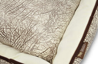 Close-up of P.L.A.Y. Savannah Lounge Bed with wild grassy plains pattern and soft velvety microsuede fabric.