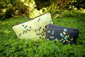 two greenery rectangle dog beds sitting in green plants