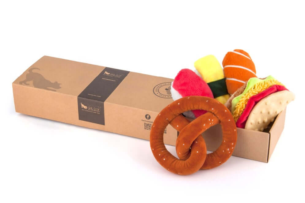 International Classic Toy Set with pretzel, taco, and sushi dog toys in a decorative box. Perfect playful treat for adventurous pups.