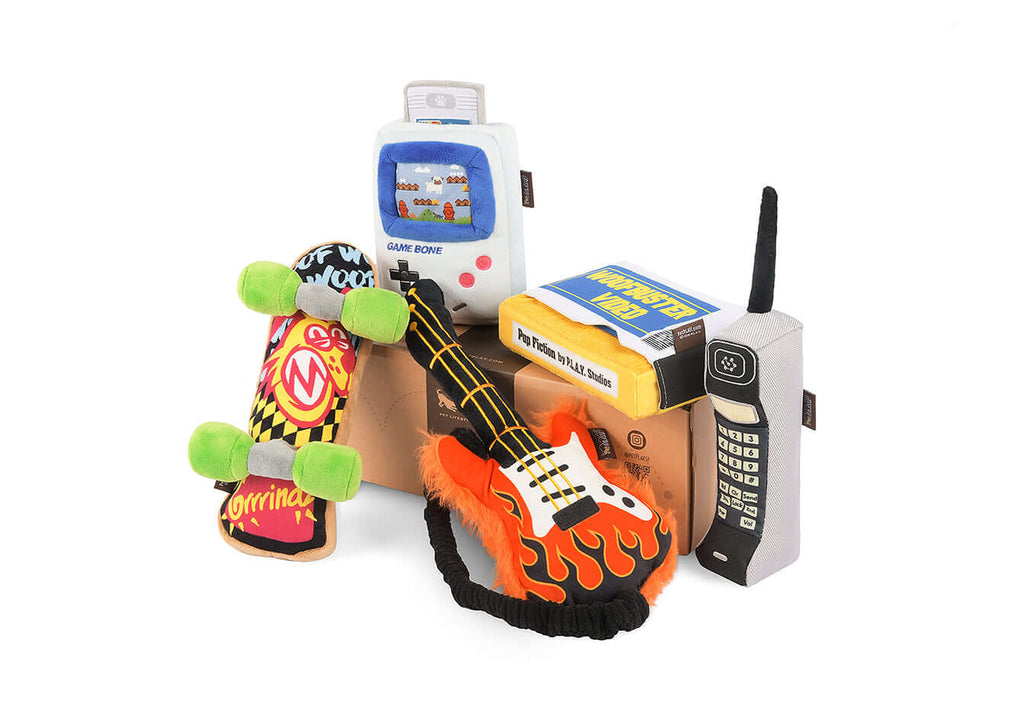 90s Classic Toy Set for Dogs with plush skateboard, game console, guitar, boombox, and mobile phone.