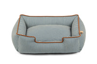 Striped bolster style dog bed with raised sides for headrest, designed in sleek fabric for comfort by P.L.A.Y. Manhattan Lounge Beds