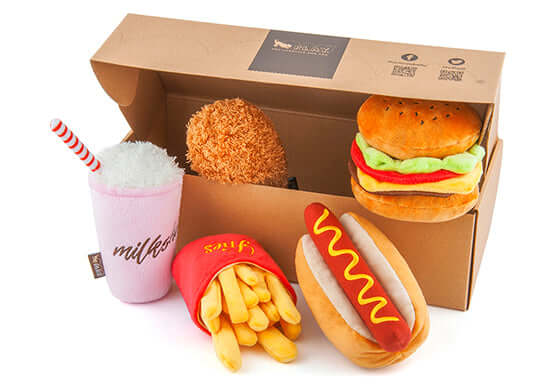 Toy set of plush burger, fries, hot dog, chicken leg, and milkshake for dogs in a box.