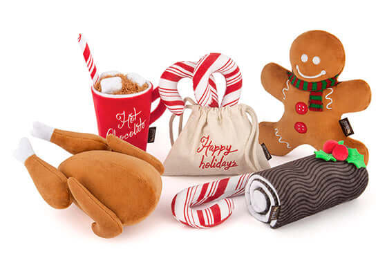 Holiday-themed dog toys set featuring plush gingerbread man, turkey, candy canes, hot chocolate, and yule log with squeaker.