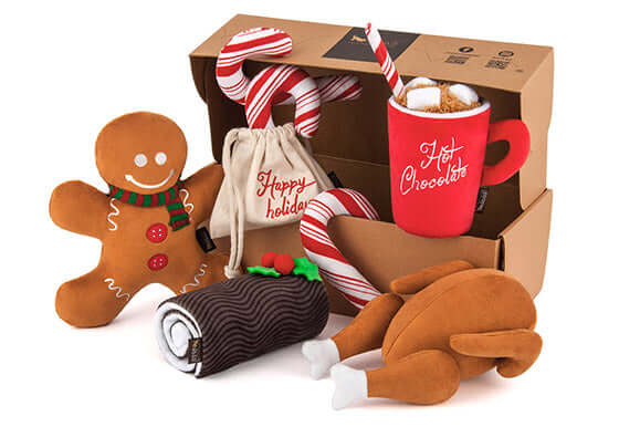 P.L.A.Y. Holiday Classic Toy Set featuring plush Gingerbread Man, Candy Canes, Hot Chocolate, Yule Log, and stuffed Turkey dog toys.