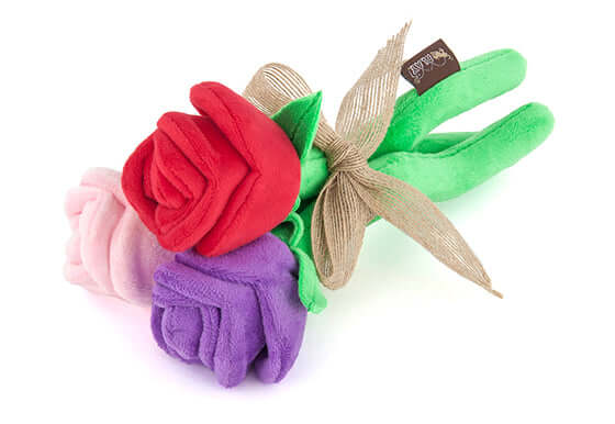 Plush bouquet flower dog toy from P.L.A.Y. Puppy Love Collection in red, pink, and purple colors with a decorative bow.