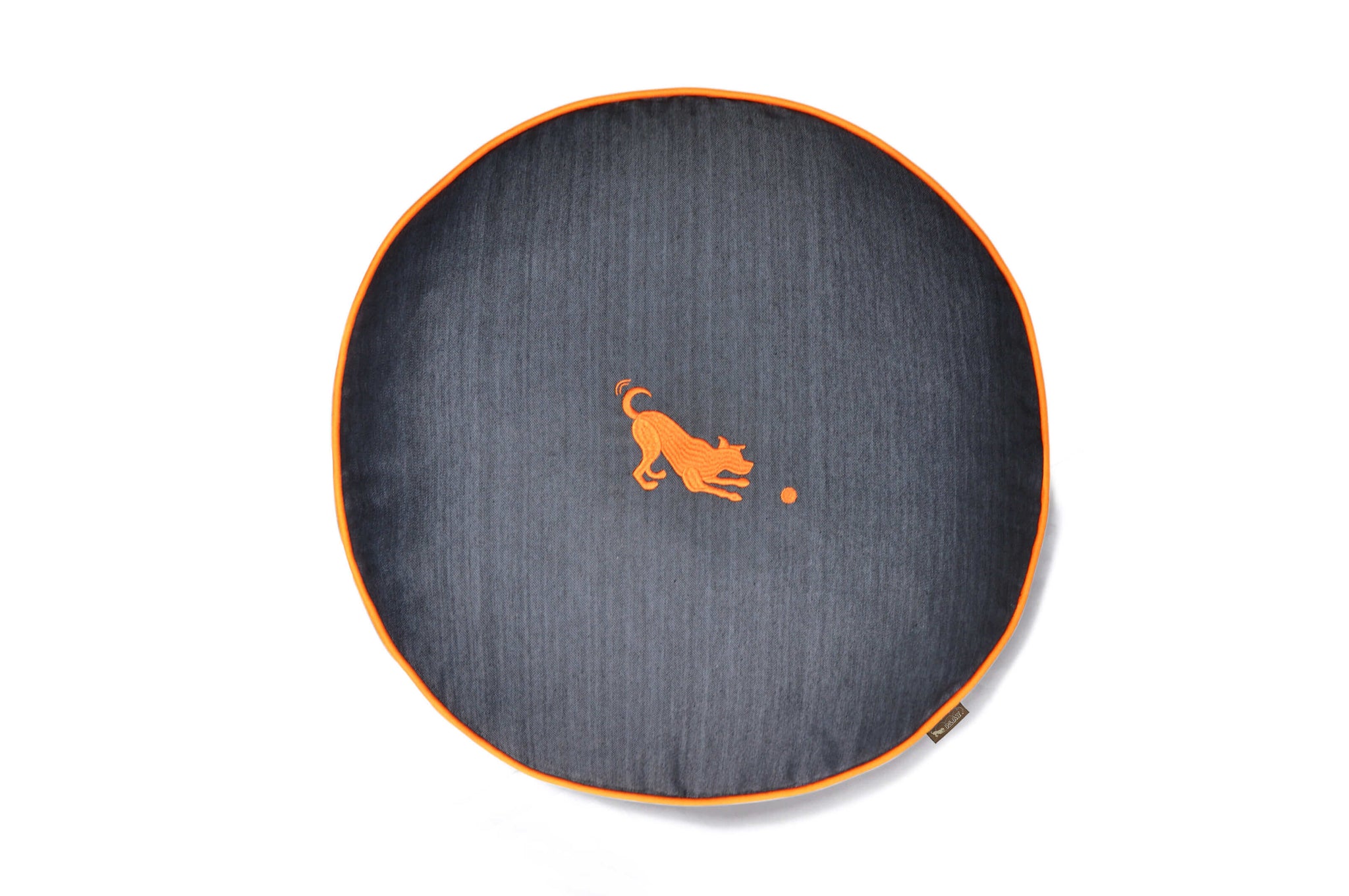 P.L.A.Y. Urban Denim Round Bed for dogs, with orange piping and playful dog emblem, providing a cozy and stylish lounging spot.