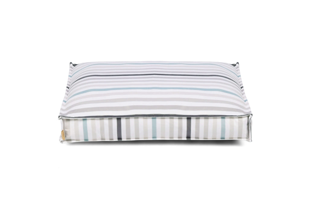 Stylish striped dog bed with contemporary design and reversible cover for a fresh look, perfect for any home décor.