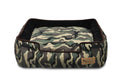 P.L.A.Y. Camouflage Lounge Bed for pets, featuring raised sides and comfortable design for dogs, with a stylish green and brown camouflage pattern.