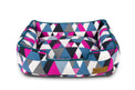 P.L.A.Y. Mosaic Lounge Bed with colorful geometric pattern in blue, pink, and white for stylish pet comfort.