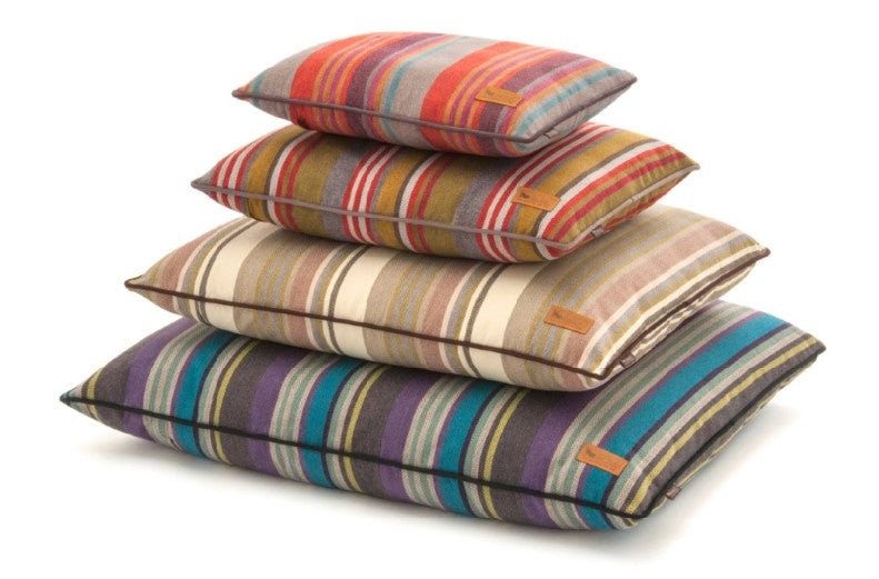 P.L.A.Y. Horizon Pillow Beds in stacked arrangement showcasing colorful, striped durable woven fabric for cozy pet lounging.