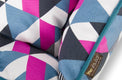 Close-up of colorful geometric pattern on P.L.A.Y. Mosaic Lounge Bed with bold pink, blue, and white shapes.